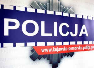 Zdjęcie przedstawia fragment gwiazdy policyjnej z napisem Policja