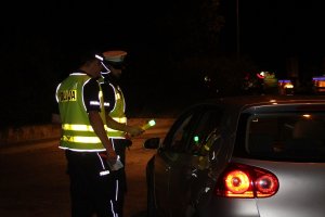 Zdjęcie przedstawia policjantów ruchu drogowego badających trzeźwość kierowców