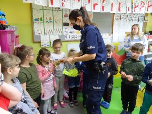 policjantka rozdaje dzieciom odblaski