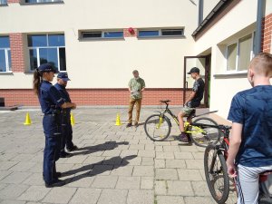 policjanci prowadzą pogadankę z uczestnikami egzaminu na kartę rowerową