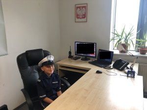 chłopiec siedzi za biurkiem komendanta