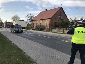 policjant mierzy prędkość nadjeżdżającego auta