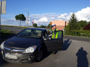 policjant kontroluje pojazd osobowy